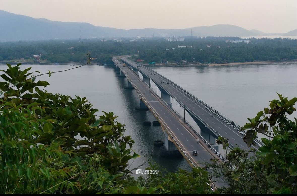 Karwar Karnataka — aerial view of Kali river bridge with scenic coastal town and Arabian Sea in background