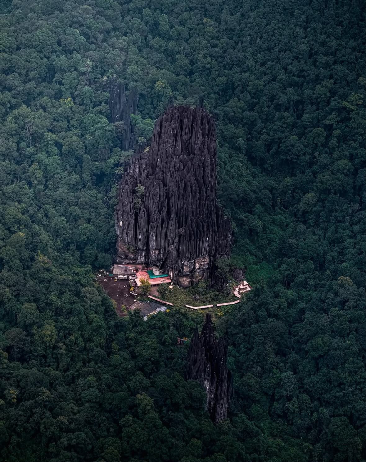 Yana Caves Karnataka — dramatic black limestone rock formations rising from dense Western Ghats forest canopy